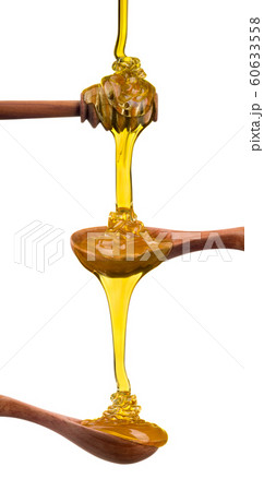 Set of wooden spoon with falling and flowing honey on them isolated on white 60633558