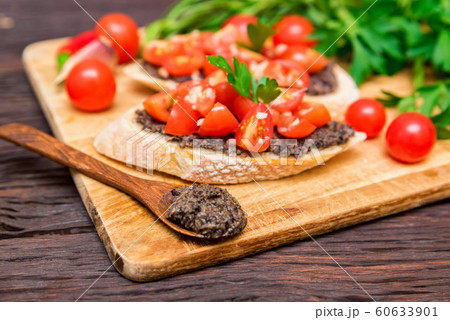 Fresh tasty bruschetta with truffle sauce, chili, parsley, tomates. Close view Fresh tasty bruschetta with truffle sauce, chili, parsley, tomates. Close view 60633901