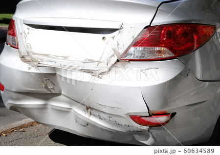 Close-up wrecked rear bumper and tail lights of new modern grey car after vehicle accident on road at bright sunny day Close-up wrecked rear bumper and tail lights of new modern grey car after vehicle accident on road at bright sunny day 60634589