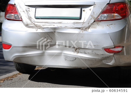 Close-up wrecked rear bumper and tail lights of new modern grey car after vehicle accident on road at bright sunny day 60634591