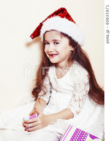 little cute girl in santas red hat waiting for Christmas gifts. holiday lifestyle people concept little cute girl in santas red hat waiting for Christmas gifts. holiday lifestyle people concept 60635971