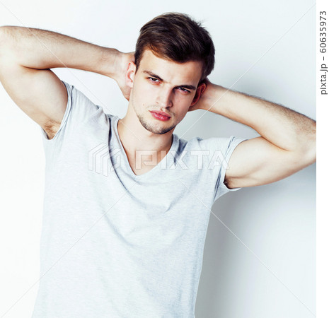 young handsome teenage hipster guy posing emotional, happy smiling against white background isolated, lifestyle people concept close up young handsome teenage hipster guy posing emotional, happy smiling against white background isolated, lifestyle people concept close up 60635973