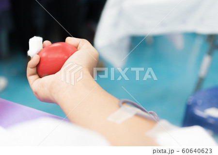 Nurse receiving blood from blood donor in hospital 60640623