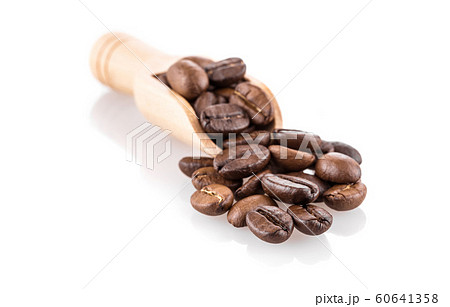 Fresh coffee beans in wooden spoon isolated on white background Fresh coffee beans in wooden spoon isolated on white background 60641358