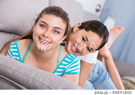 Two cheerful teenagers girls on sofa Two cheerful teenagers girls on sofa 60641800