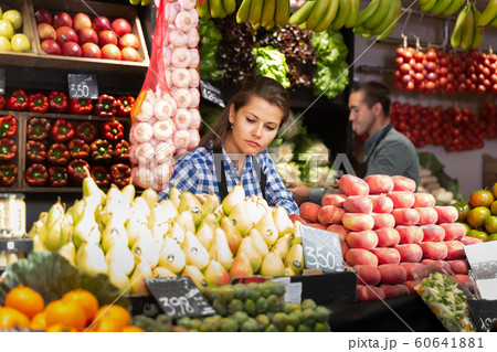Posing happy woman and working man in fruit shop Posing happy woman and working man in fruit shop 60641881