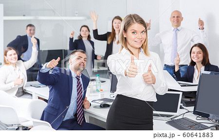 Woman with adult team celebrating victory Woman with adult team celebrating victory 60641883