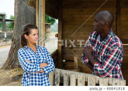 Angry woman quarreling with her afro-american male neighbor Angry woman quarreling with her afro-american male neighbor 60641918