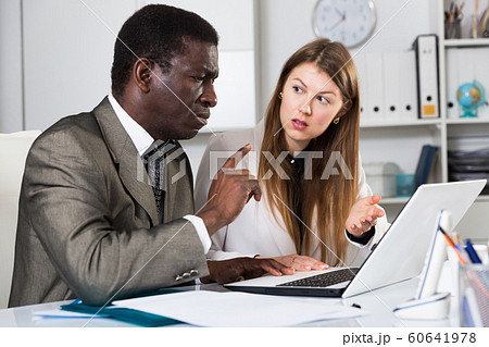 Man and woman managers with laptop working and discussing 60641978