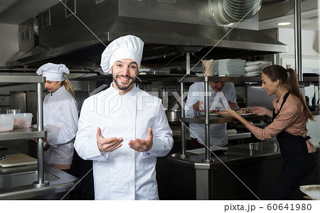 Chef in kitchen with busy staff 60641980