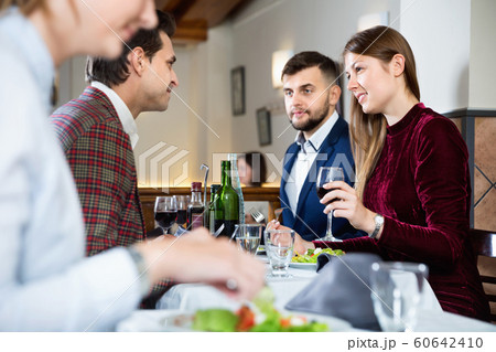 Friendly meeting over dinner with wine in restaurant 60642410