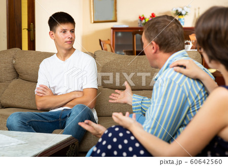 Male and female quarrelling with their son Male and female quarrelling with their son 60642560