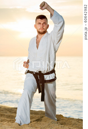 Adult guy practising karate kata poses Adult guy practising karate kata poses 60642982