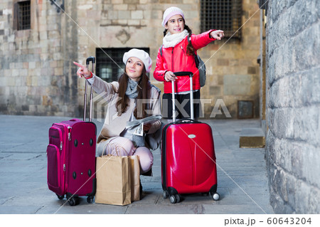 girl with mother holding map outdoors girl with mother holding map outdoors 60643204