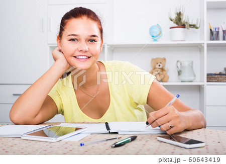 girl student sitting and studying indoors 60643419