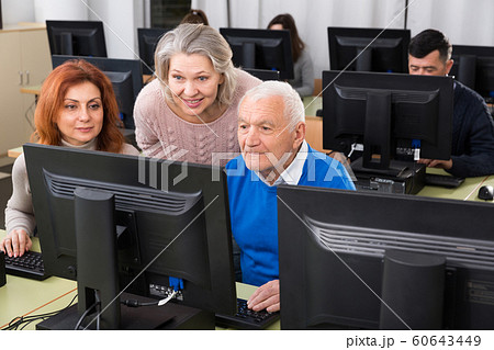 Students of different ages looking at monitor 60643449