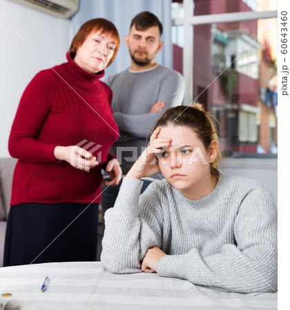 Upset woman during quarrel with family Upset woman during quarrel with family 60643460