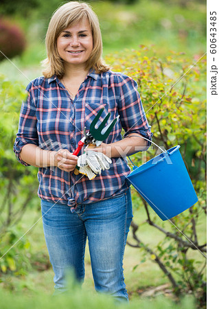 woman bucket garden 60643485