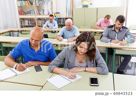 Men and women take a written exam 60643523