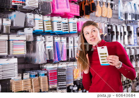 girl is selecting decorations for her hair girl is selecting decorations for her hair 60643684