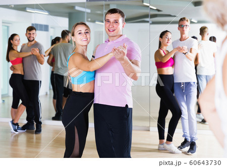 Dancing couples learning salsa at dance class Dancing couples learning salsa at dance class 60643730