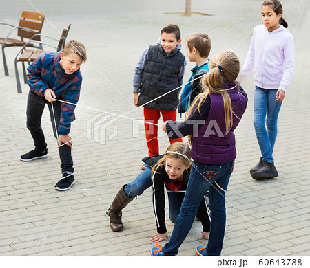 Children games. Girl goes through the tangled rope Children games. Girl goes through the tangled rope 60643788