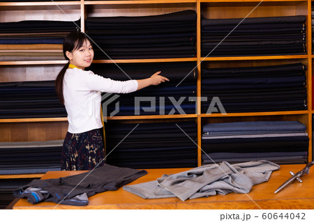Young Chinese salesgirl working in fabric store Young Chinese salesgirl working in fabric store 60644042