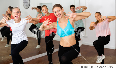 Teenagers participating in dance class with teacher 60644145