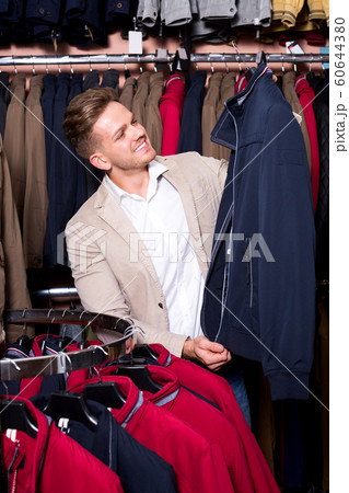Man choosing new coat 60644380