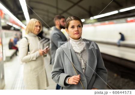 Young woman waiting for subway train Young woman waiting for subway train 60644573