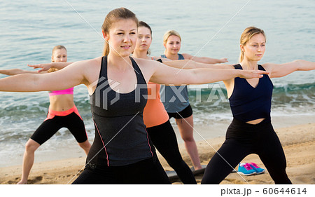Positive sporty women practicing yoga positions 60644614