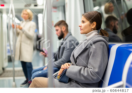 Pretty woman in public land transport 60644817