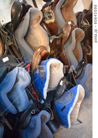 Different seats for horse riding at horse stable, nobody Different seats for horse riding at horse stable, nobody 60645099