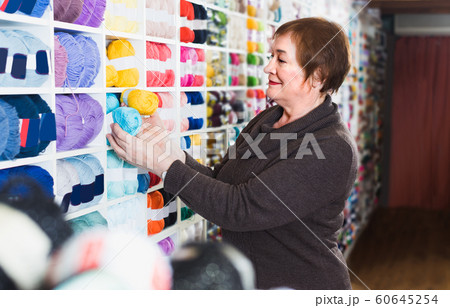 Client is buying colorful yarn for their hobby 60645254
