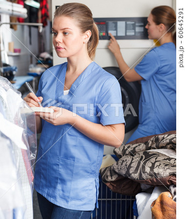 Girl working at dry cleaner 60645291