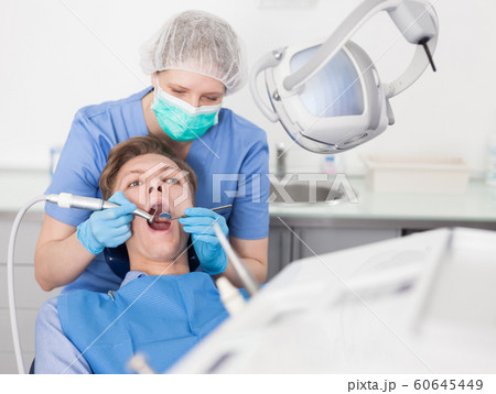 Young man on dental checkup in modern dentist office 60645449