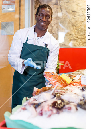 Salesman offering fresh fish Salesman offering fresh fish 60645566