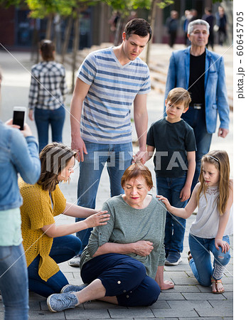 People helping sad grandmother with pain in heart 60645705