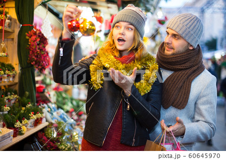 Girl with boy delighted with purchases at Christmas market 60645970