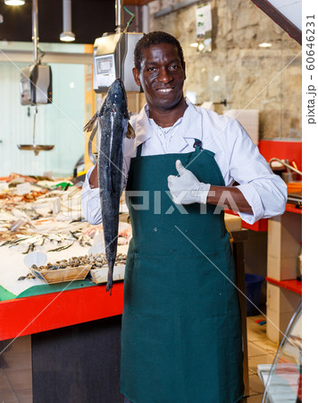 Salesman offering fresh fish Salesman offering fresh fish 60646231