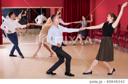 Young group people dancing lindy hop in pairs 60646342