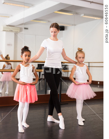 Dance teacher helping her little girls students Dance teacher helping her little girls students 60646550