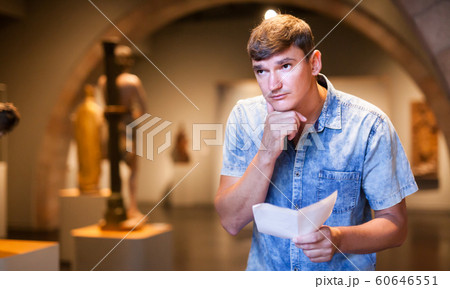 Man with brochure looking at exposition Man with brochure looking at exposition 60646551