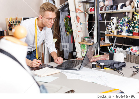 Tailor creating pattern using graphics tablet Tailor creating pattern using graphics tablet 60646796