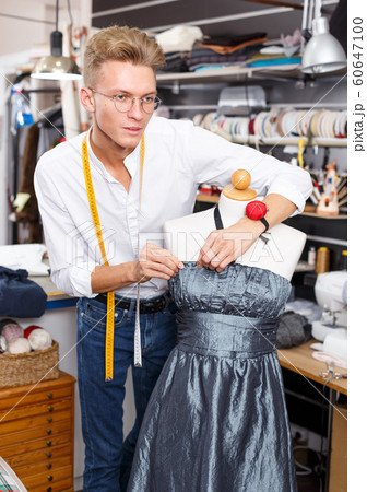 Dressmaker using tape measure Dressmaker using tape measure 60647100