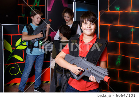 Portrait of teen boy standing with laser gun Portrait of teen boy standing with laser gun 60647101