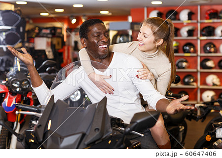 Couple posing on purchased motorcycle Couple posing on purchased motorcycle 60647406