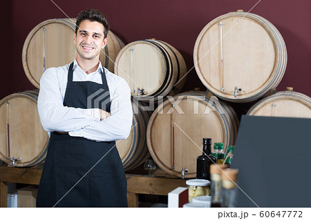 man in uniform standing in store wine section with woods man in uniform standing in store wine section with woods 60647772