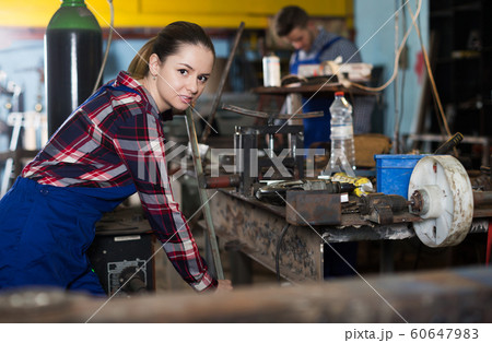woman master is standing near vise equipment woman master is standing near vise equipment 60647983