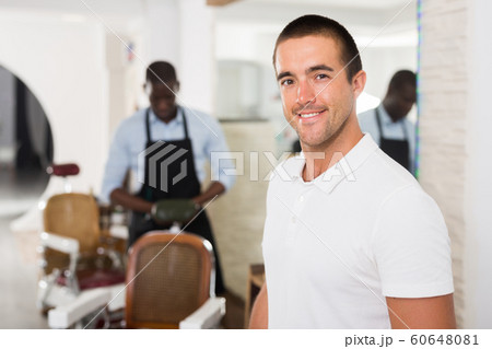 Satisfied man at hairdresser Satisfied man at hairdresser 60648081